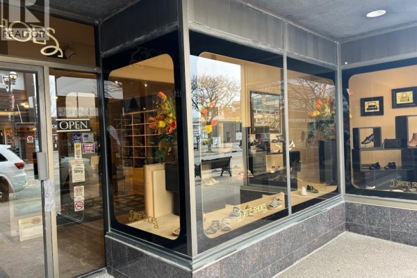 Storefront window display featuring shoes and floral arrangements. - 1329 Ottawa, Windsor