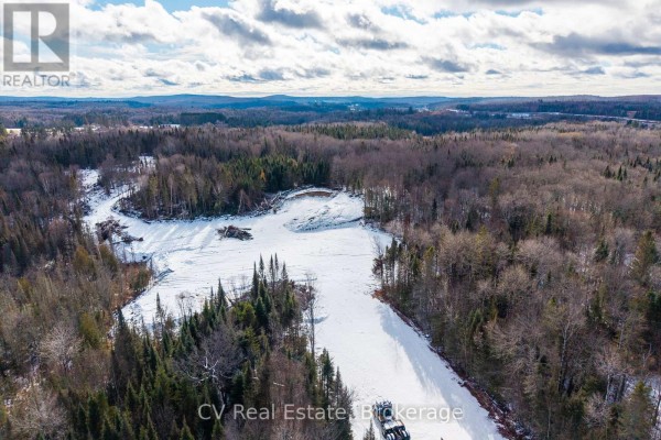 Snowy terrain with a hill and scattered trees, under a cloudy sky. - 133 Berriedale Road, Armour