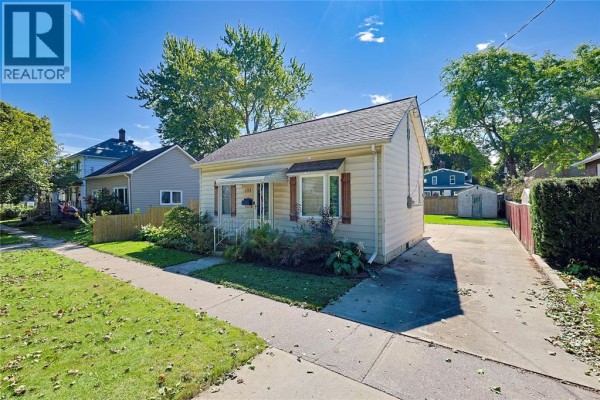 View of the 133 Bright Street bungalow from the driveway, showing the side and backyard. - 133 Bright Street, Sarnia
