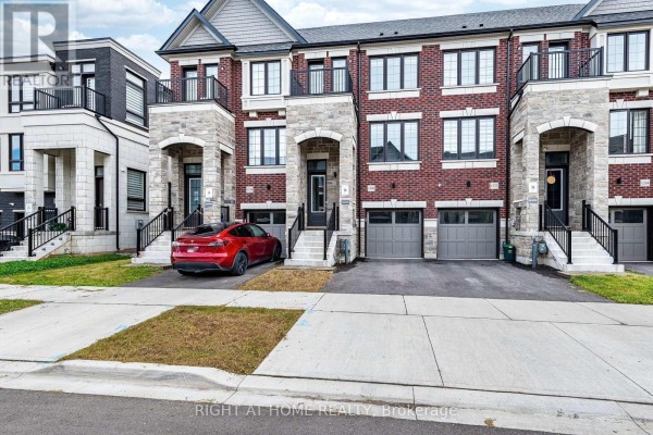 Close-up exterior view of a townhouse at 1330 Shevchenko Boulevard, Oakville with a red car parked in driveway. - 1330 Shevchenko Boulevard, Oakville