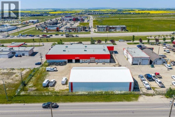 High angle view of the commercial building and parking lot with a pylon sign. - 13313 100 Street, Grande Prairie