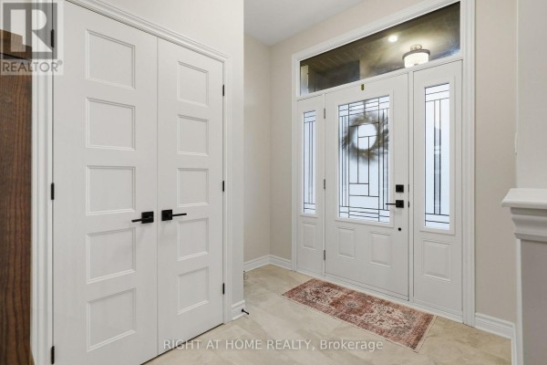 Close-up of the front entrance with a covered porch and stone accents. - 1334 Fribourg Street, Russell