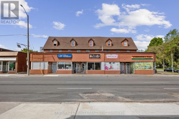 Front exterior view of a commercial building with multiple businesses, large windows, and signage. - 134-142 Simcoe Street S, Oshawa