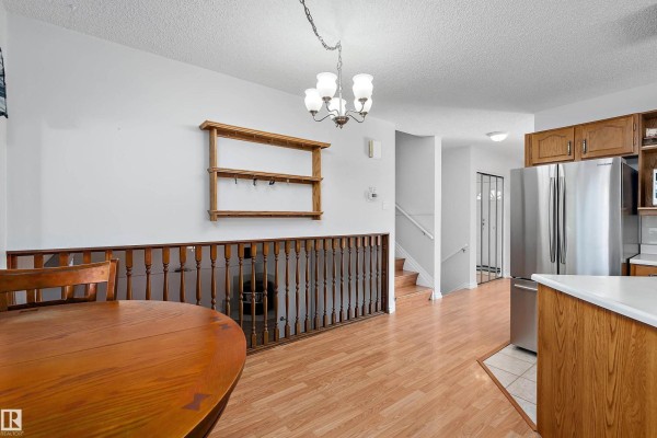 Kitchen with oak cabinets, stainless steel appliances, a countertop island, and a double door closet. - 134 Cameron Cr, Wetaskiwin