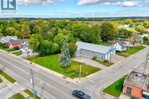 Panoramic aerial view of a town intersection with vacant land, residential homes, and fields. - 134 County Rd 34 W., Cottam