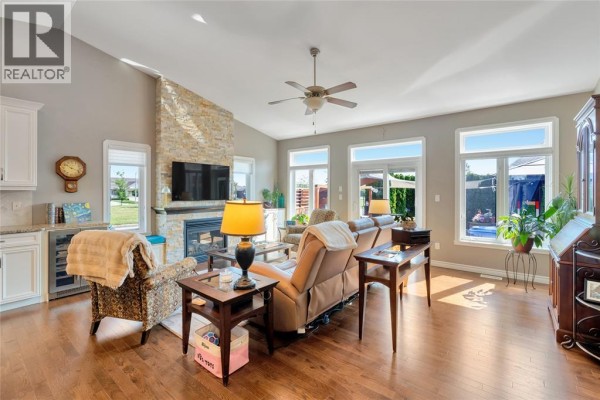 Open concept kitchen and living room with granite island and stone fireplace. - 1340 Aspenshore, Windsor