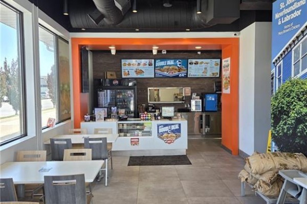 Close-up of the service counter inside Mary Browns Chicken with menu boards and kitchen equipment visible. - 13430 Tecumseh Road E, Tecumseh