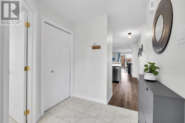 Entryway with storage cabinet, mirror, and window view - 1344 Guthrie Street, Ottawa