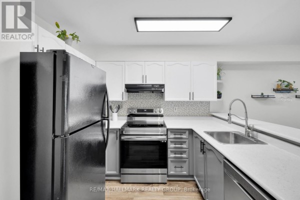 Modern kitchen with stainless steel appliances, white cabinets, and open layout - 1344 Guthrie Street, Ottawa