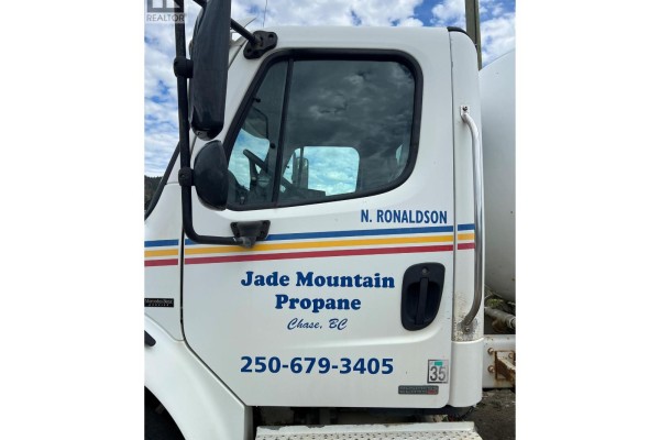 Close-up of white propane truck cab door with Jade Mountain Propane logo and phone number. - 1345 Cardy Drive, Scotch Creek
