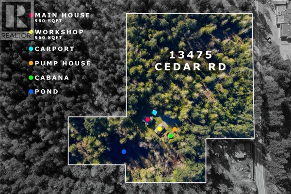 Covered wooden deck with outdoor furniture, a grill, and wood-paneled exterior walls. - 13475 Cedar Rd, Ladysmith