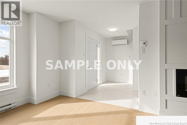 Interior room with white walls, a white door, beige tiled floor, and wooden floors near a window. - 135 Beau Domaine Court, Dieppe