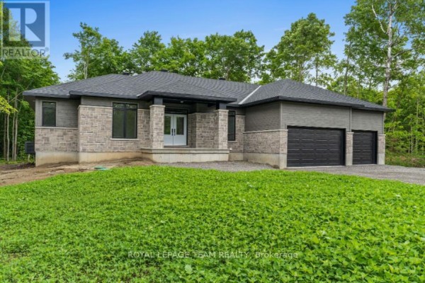 View of the front entrance of a contemporary house with stone and grey siding. - 135 Upton Drive, Beckwith