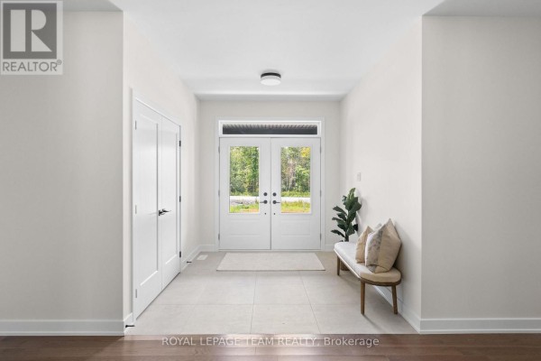 Interior entryway with double doors, light-colored tile floor, and a bench with pillows. - 135 Upton Drive, Beckwith