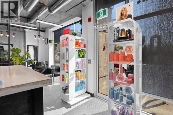 Retail display shelves filled with hair products in front of the salon entrance. - 1350 St Paul Street Unit# 102, Kelowna