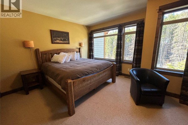 Hallway with tiled floors, wooden stairs, and multiple doors. - 1351 Gerry Sorensen Way Unit# N3a, Kimberley