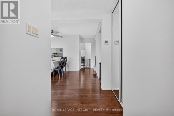View from hallway looking into dining area with a table, chairs, and a kitchen beyond. - 1352 Bakker Court, Ottawa