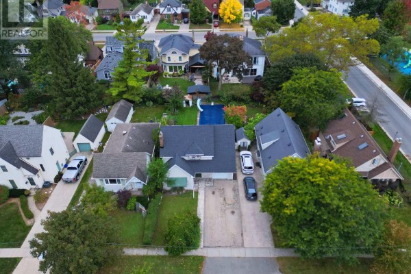 High aerial view of the residential street with multiple houses, yards, and trees. - 136 Highland Avenue, St  Catharines