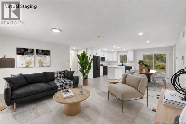 Bright, open-concept living and kitchen area with white cabinets, a white island, and light grey wood-look flooring. - 136 Horseman Road, Fredericton Junction