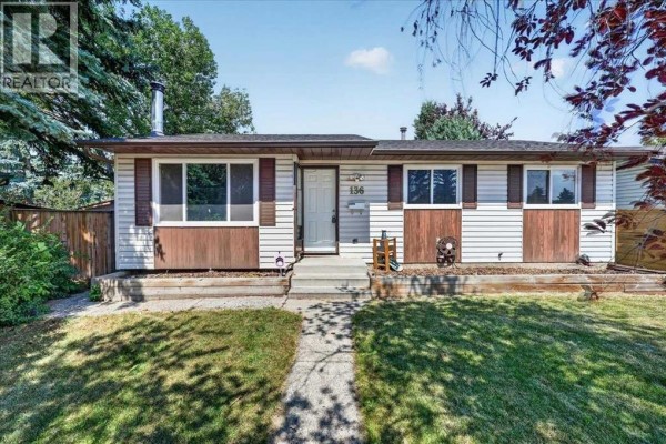 Front view of the house with a paved walkway and green lawn. - 136 Templeview Place Ne, Calgary