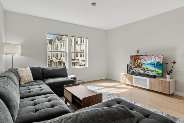 A row of beige and grey townhouses with attached garages and red doors. - 137 32633 Simon Avenue, Abbotsford