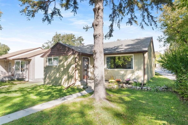 Front exterior of a bungalow with tan siding and brown trim under a grey roof. - 137 Kilbride Avenue, Winnipeg