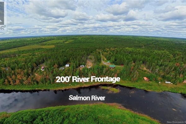 Aerial view showing the Salmon River with 200 feet of river frontage and wooded landscape. - 1374 Route 116, Salmon River Rd