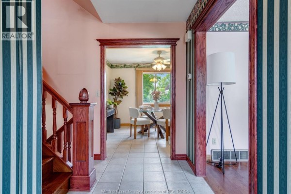 View from hallway looking into a dining room with a round table and chairs. - 1379 Oxford Ave, Kingsville