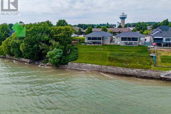 Waterfront homes with manicured lawns and stone retaining walls along the water's edge. - 138 Brown Street, Norfolk
