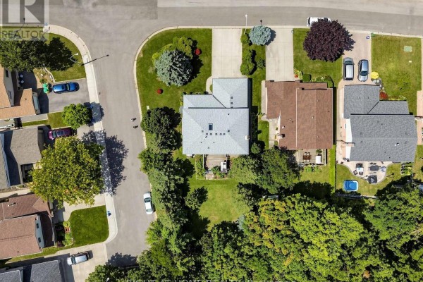 Top-down aerial view of a house with a backyard, garden, and surrounding homes. - 138 Strawberry Drive, Hamilton