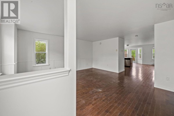 Kitchen and dining area with dark wood cabinets, island, and bay window with backyard view. - 138 Transom Drive, Halifax