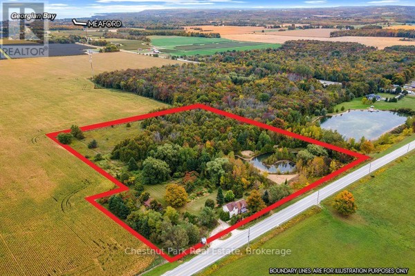 Aerial view of the property boundaries marked in red, showing the house and pond. - 138237 Grey Road 112, Meaford