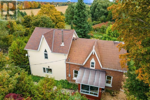 Close-up aerial view of the brick and cream-colored two-story house. - 138237 Grey Road 112, Meaford