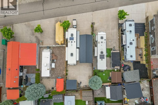 Overhead drone view of RV parking spaces with RVs, covered structures, and small buildings. - 1383 Silver Sands Road Unit# 109, Sicamous
