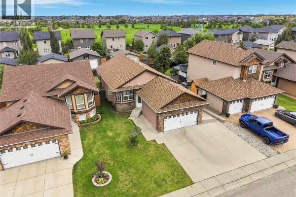 Aerial view of residential neighborhood showing multiple houses and a golf course in distance. - 139 Brainerd Crescent, Saskatoon
