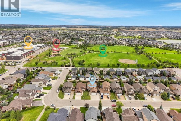 Aerial view of a suburban neighborhood with houses and green spaces. - 139 Brainerd Crescent, Saskatoon