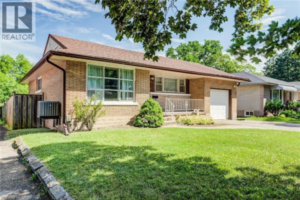 Front view of the bungalow with a stone garden border and air conditioning unit. - 139 Elgin Crescent, Waterloo