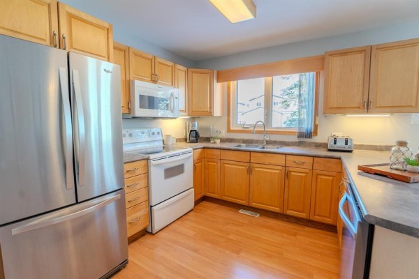 Kitchen showcasing wooden cabinets, stainless steel appliances, and ample counter space - 1392 Ravelston Avenue, Winnipeg