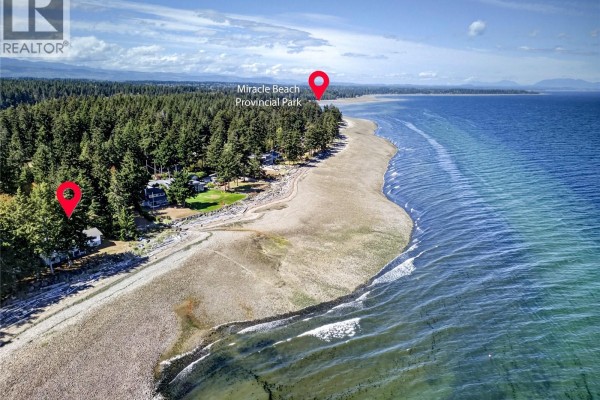 Aerial view showing the property's location near Miracle Beach Provincial Park and other residences. - 1394 Seaview Rd, Black Creek