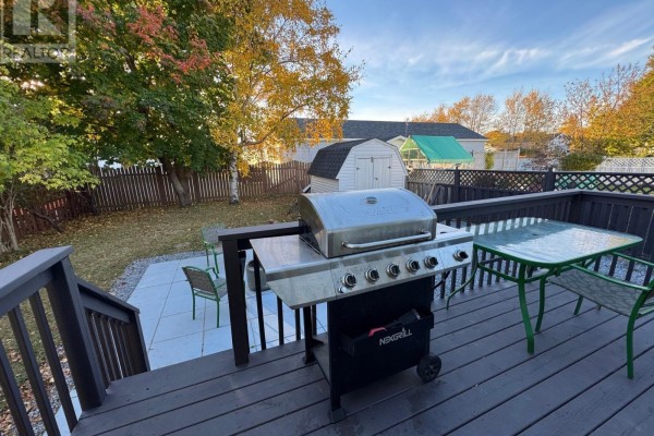 Wooden deck with a stainless steel grill, chairs, and a glass-top table. - 13a O'brien's Drive, Stephenville