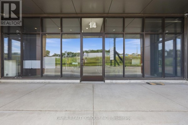 Close-up of the glass entrance at unit 14 with signage above. - 14 - 35 Stoffel Drive, Toronto