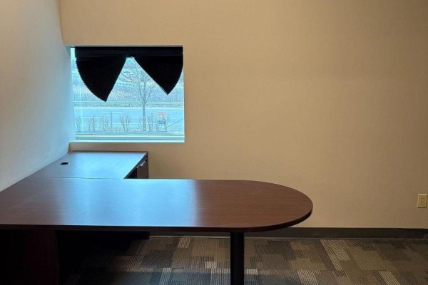 Corner of an office room with large windows showing an outdoor view and grey patterned carpet. - 14 - 595 Cityview Boulevard, Vaughan