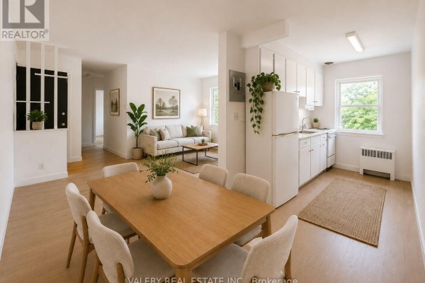 Open concept dining area with wooden table and chairs, adjacent to kitchen. - 14 - 917 Hamilton Road, London East