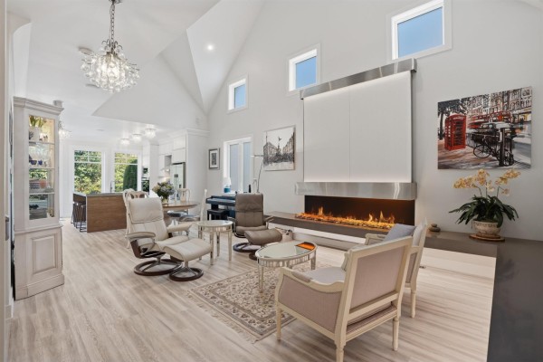 Spacious living area with a modern fireplace and vaulted ceiling. - 14 3122 160th Street, Surrey