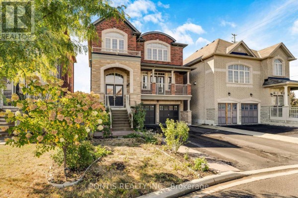 Front exterior of a two-story house with brick and stone facade and landscaping. - 14 Arrowstone Court, Brampton
