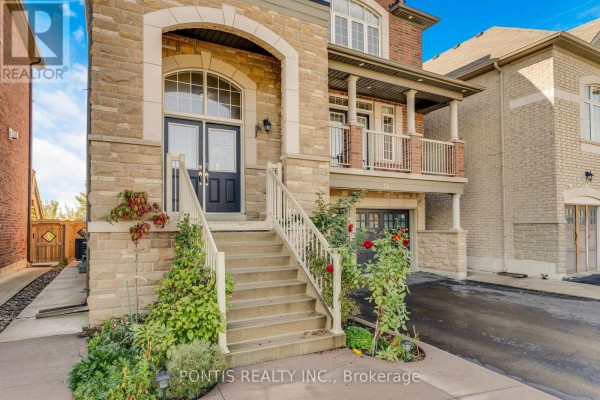 Close-up of the front entrance stairs and arched stone entryway of a house. - 14 Arrowstone Court, Brampton