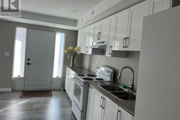 Kitchen area with white cabinets, granite countertops, and a white stove. - 14 #basement - 3029 Finch Avenue W, Toronto