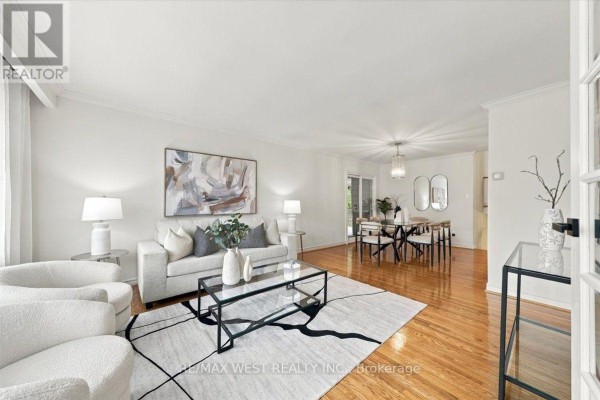 Living and dining room with hardwood floors, neutral furniture, and modern decor. - 14 Burnhamill Place, Toronto