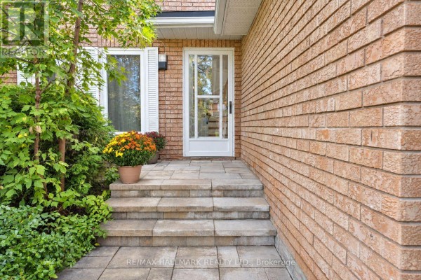 Close-up of the front entrance steps and door with stone pavers and brick exterior. - 14 Crawford Rose Drive, Aurora