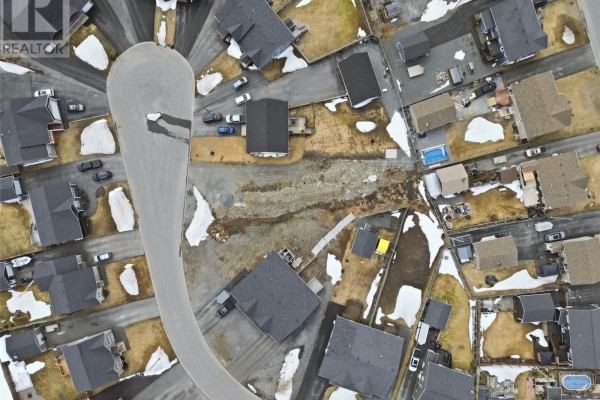 High aerial view of a cul-de-sac surrounded by houses and undeveloped residential lots. - 14 Esmonde Place, Gander